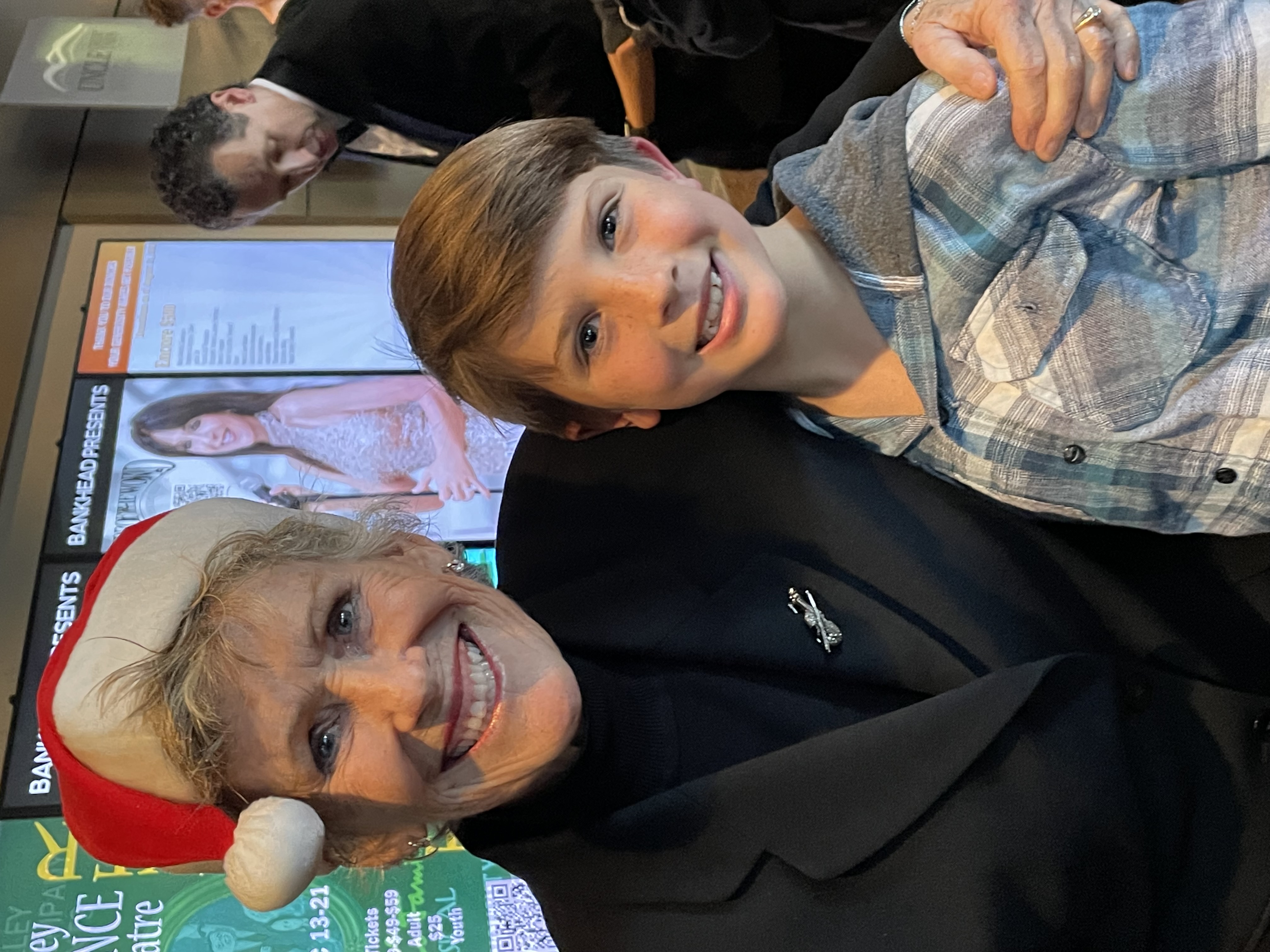 child attends with LAS violin player in Santa hat Lisa Burkhart