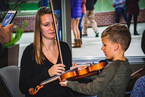 child meets violin with LAS player Amanda Bewley