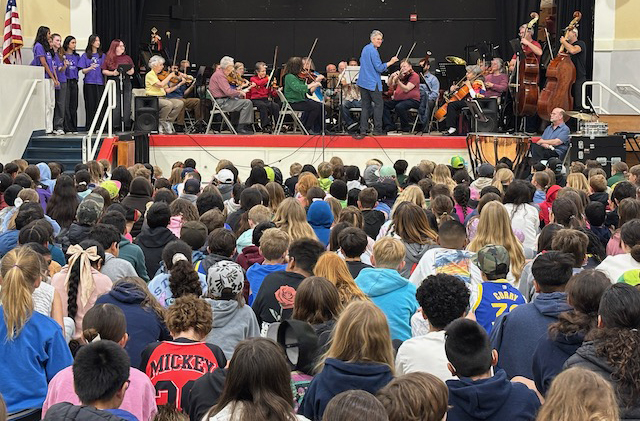 orchestra and singers performing at Sunset School